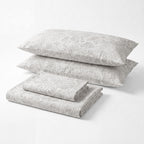 Sofia Home Textiles Printed Bedsheets - Sofia Flowers Printed Double Flat Bedsheet Set 4 Pcs in Grey folded full set on a white background - مفروشات صوفيا - ملايات مطبوعة - طقم ملاية صوفيا ورد دبل مسطحة 4 قطع باللون رمادي مطوي كامل على خلفية بيضاء