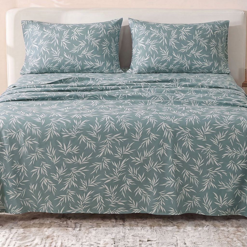 Sofia Home Textiles Printed Bedsheets - Sofia Leaves Printed Double Flat Bedsheet Set 4 Pcs (240 × 260 cm) in Teal spread on a double bed - مفروشات صوفيا - ملايات مطبوعة - طقم ملاية صوفيا ورق شجر دبل مسطحة 4 قطع (240 × 260 سم) باللون جنزاري مفروش على سرير دبل