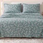 Sofia Home Textiles Printed Bedsheets - Sofia Leaves Printed Double Flat Bedsheet Set 4 Pcs (240 × 260 cm) in Teal spread on a double bed - مفروشات صوفيا - ملايات مطبوعة - طقم ملاية صوفيا ورق شجر دبل مسطحة 4 قطع (240 × 260 سم) باللون جنزاري مفروش على سرير دبل