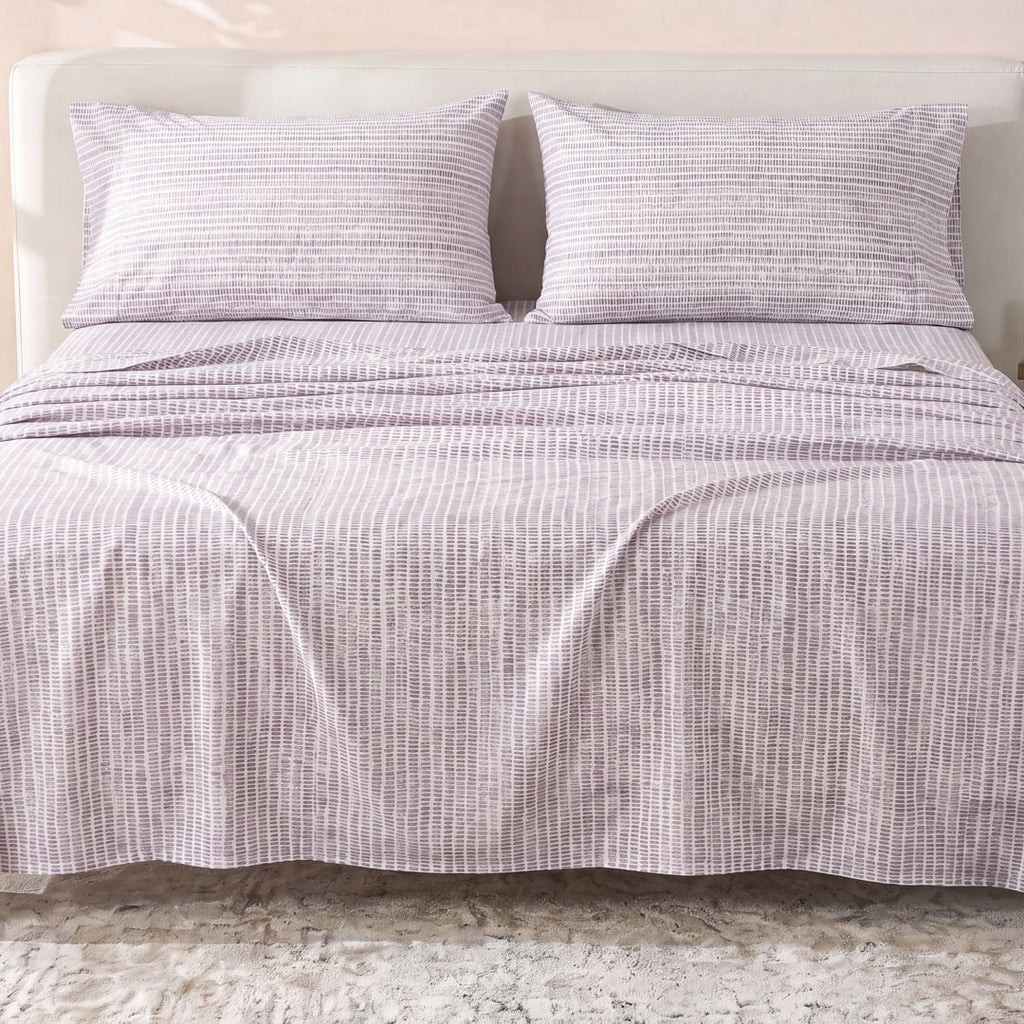 Sofia Home Textiles Printed Bedsheets - Sofia Lines Printed Double Flat Bedsheet Set 4 Pcs (240 × 260 cm) in Purple spread on a double bed - مفروشات صوفيا - ملايات مطبوعة - طقم ملاية صوفيا خطوط دبل مسطحة 4 قطع (240 × 260 سم) باللون بنفسجي مفروش على سرير دبل