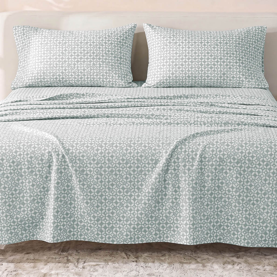 Sofia Home Textiles Printed Bedsheets - Sofia Geometric Flowers Printed Double Flat Bedsheet Set 4 Pcs (240 × 260 cm) in Light Blue spread on a double bed - مفروشات صوفيا - ملايات مطبوعة - طقم ملاية صوفيا ورد هندسي دبل مسطحة 4 قطع (240 × 260 سم) باللون أزرق فاتح مفروش على سرير دبل