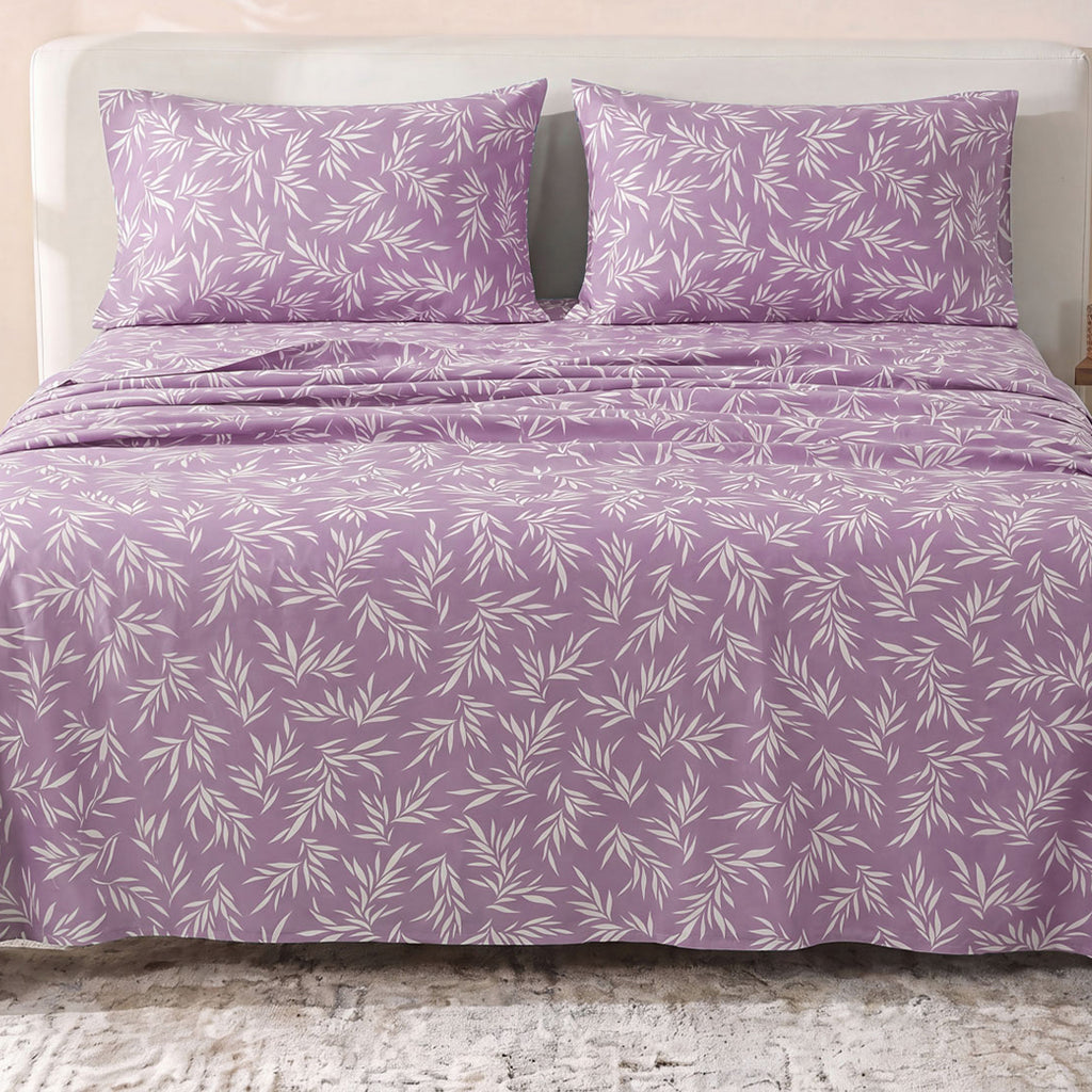 Sofia Home Textiles Printed Bedsheets - Sofia Leaves Printed Double Flat Bedsheet Set 4 Pcs (240 × 260 cm) in Purple spread on a double bed - مفروشات صوفيا - ملايات مطبوعة - طقم ملاية صوفيا ورق شجر دبل مسطحة 4 قطع (240 × 260 سم) باللون بنفسجي مفروش على سرير دبل