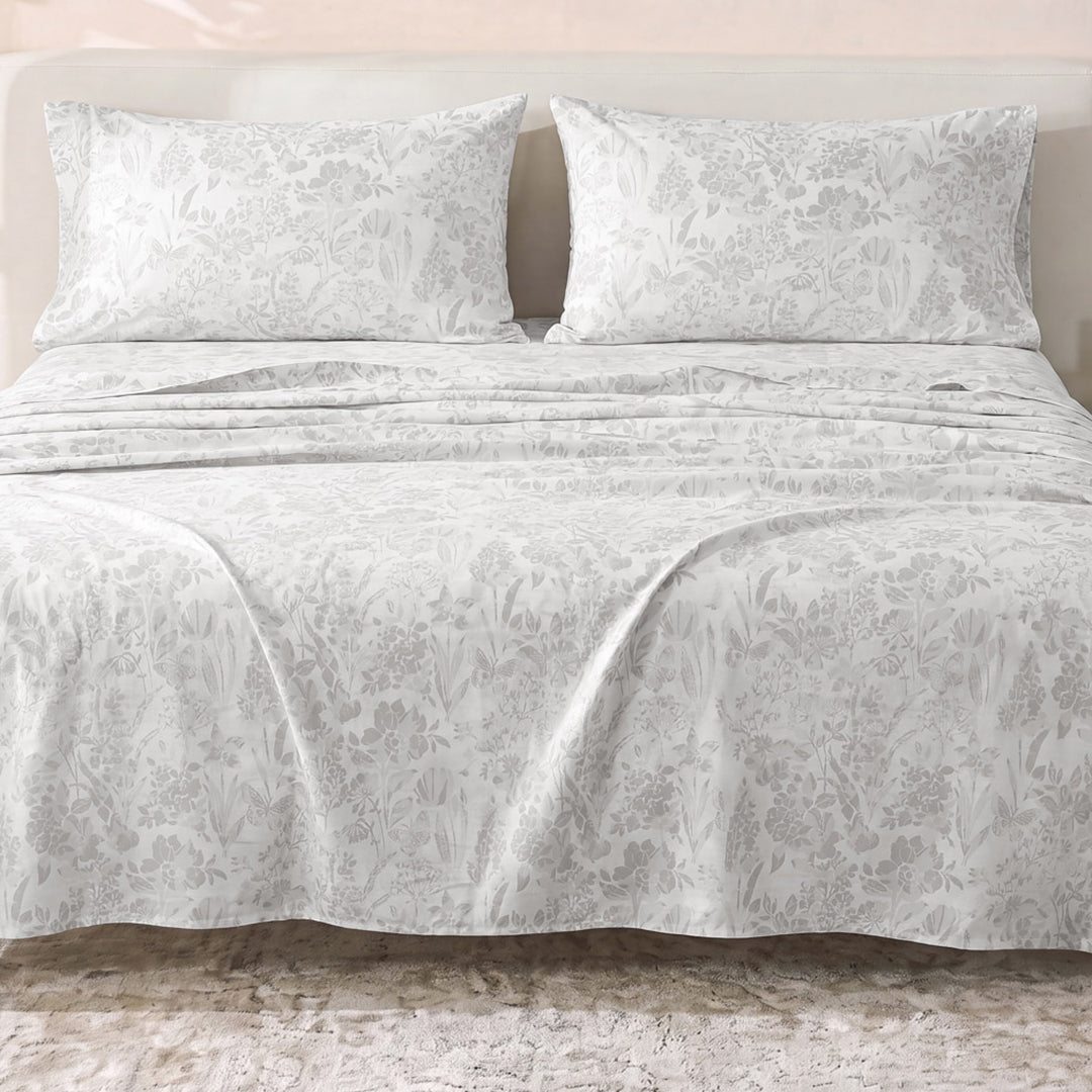 Sofia Home Textiles Printed Bedsheets - Sofia Flowers Printed Double Flat Bedsheet Set 4 Pcs (240 × 260 cm) in Grey spread on a double bed - مفروشات صوفيا - ملايات مطبوعة - طقم ملاية صوفيا ورد دبل مسطحة 4 قطع (240 × 260 سم) باللون رمادي مفروش على سرير دبل