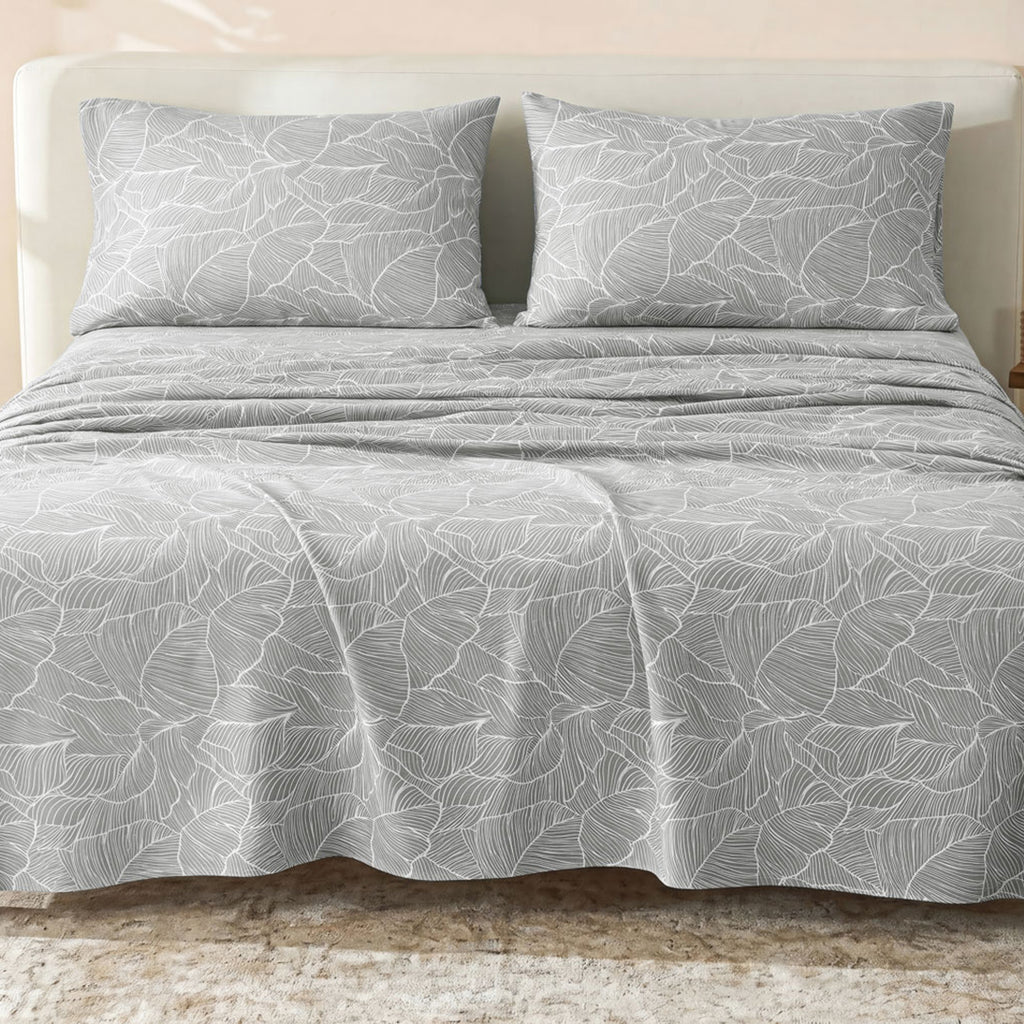 Sofia Home Textiles Printed Bedsheets - Sofia Large Leaves Printed Double Flat Bedsheet Set 4 Pcs (240 × 260 cm) in Grey spread on a double bed - مفروشات صوفيا - ملايات مطبوعة - طقم ملاية صوفيا ورق شجر كبير دبل مسطحة 4 قطع (240 × 260 سم) باللون رمادي مفروش على سرير دبل