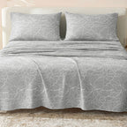 Sofia Home Textiles Printed Bedsheets - Sofia Large Leaves Printed Double Flat Bedsheet Set 4 Pcs (240 × 260 cm) in Grey spread on a double bed - مفروشات صوفيا - ملايات مطبوعة - طقم ملاية صوفيا ورق شجر كبير دبل مسطحة 4 قطع (240 × 260 سم) باللون رمادي مفروش على سرير دبل