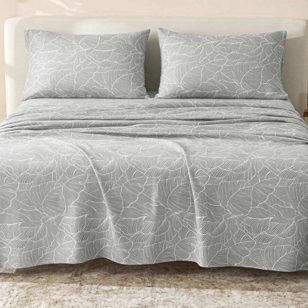 Sofia Home Textiles Printed Bedsheets - Sofia Large Leaves Printed Double Flat Bedsheet Set 4 Pcs (240 × 260 cm) in Grey spread on a double bed - مفروشات صوفيا - ملايات مطبوعة - طقم ملاية صوفيا ورق شجر كبير دبل مسطحة 4 قطع (240 × 260 سم) باللون رمادي مفروش على سرير دبل