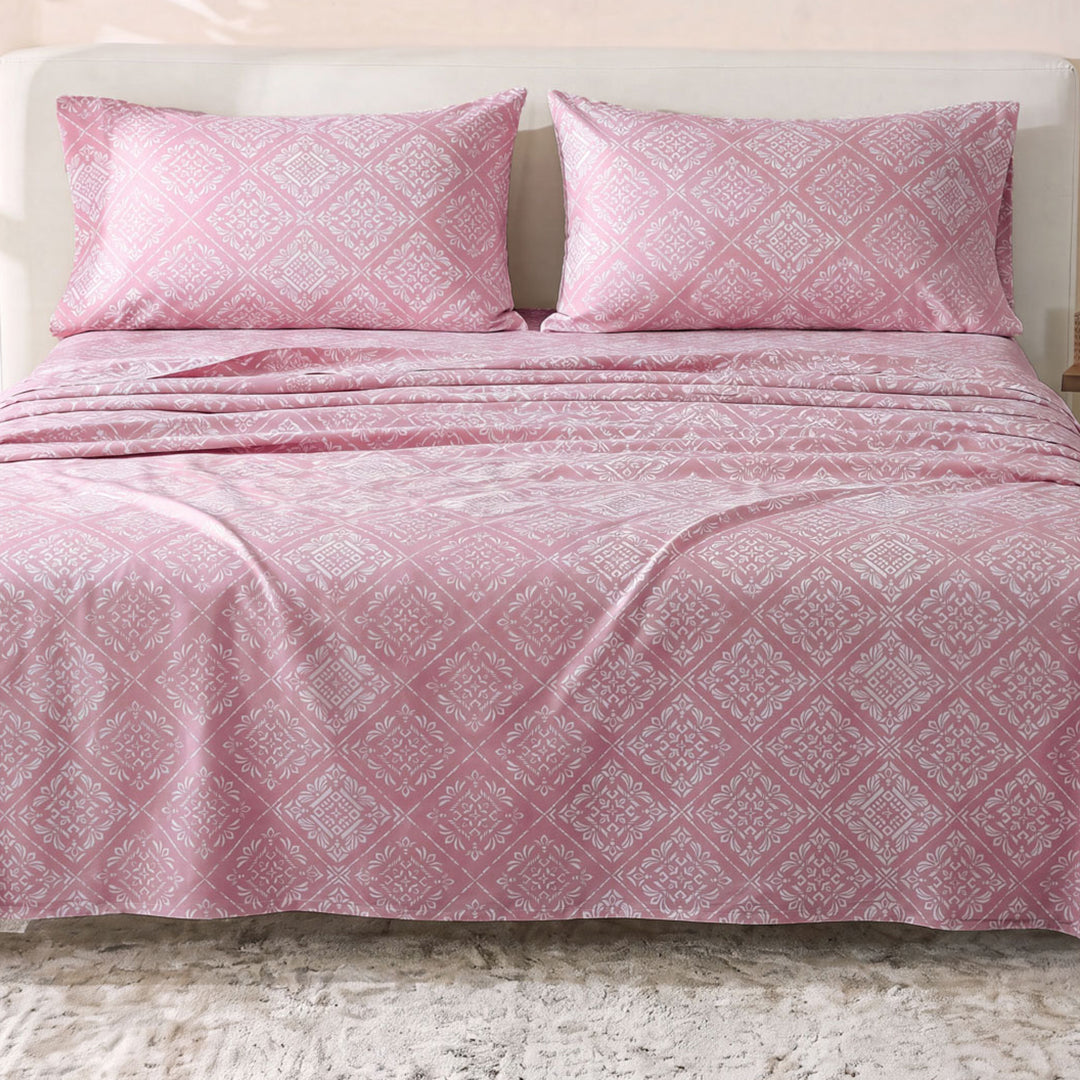Sofia Home Textiles Printed Bedsheets - Sofia Flower Squares Printed Double Flat Bedsheet Set 4 Pcs (240 × 260 cm) in Rose spread on a double bed - مفروشات صوفيا - ملايات مطبوعة - طقم ملاية صوفيا مربعات ورد دبل مسطحة 4 قطع (240 × 260 سم) باللون وردي مفروش على سرير دبل