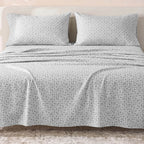 Sofia Home Textiles Printed Bedsheets - Sofia Geometric Flowers Printed Double Flat Bedsheet Set 4 Pcs (240 × 260 cm) in Dark Grey spread on a double bed - مفروشات صوفيا - ملايات مطبوعة - طقم ملاية صوفيا ورد هندسي دبل مسطحة 4 قطع (240 × 260 سم) باللون رمادي غامق مفروش على سرير دبل