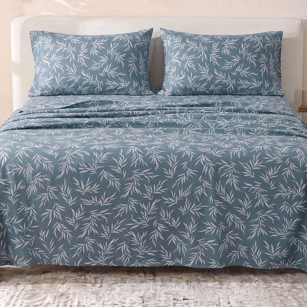 Sofia Home Textiles Printed Bedsheets - Sofia Leaves Printed Double Flat Bedsheet Set 4 Pcs (240 × 260 cm) in Petroleum spread on a double bed - مفروشات صوفيا - ملايات مطبوعة - طقم ملاية صوفيا ورق شجر دبل مسطحة 4 قطع (240 × 260 سم) باللون بترولي مفروش على سرير دبل