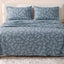 Sofia Home Textiles Printed Bedsheets - Sofia Leaves Printed Double Flat Bedsheet Set 4 Pcs (240 × 260 cm) in Petroleum spread on a double bed - مفروشات صوفيا - ملايات مطبوعة - طقم ملاية صوفيا ورق شجر دبل مسطحة 4 قطع (240 × 260 سم) باللون بترولي مفروش على سرير دبل
