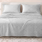 Sofia Home Textiles Printed Bedsheets - Sofia Flower Squares Printed Double Flat Bedsheet Set 4 Pcs (240 × 260 cm) in Grey spread on a double bed - مفروشات صوفيا - ملايات مطبوعة - طقم ملاية صوفيا مربعات ورد دبل مسطحة 4 قطع (240 × 260 سم) باللون رمادي مفروش على سرير دبل