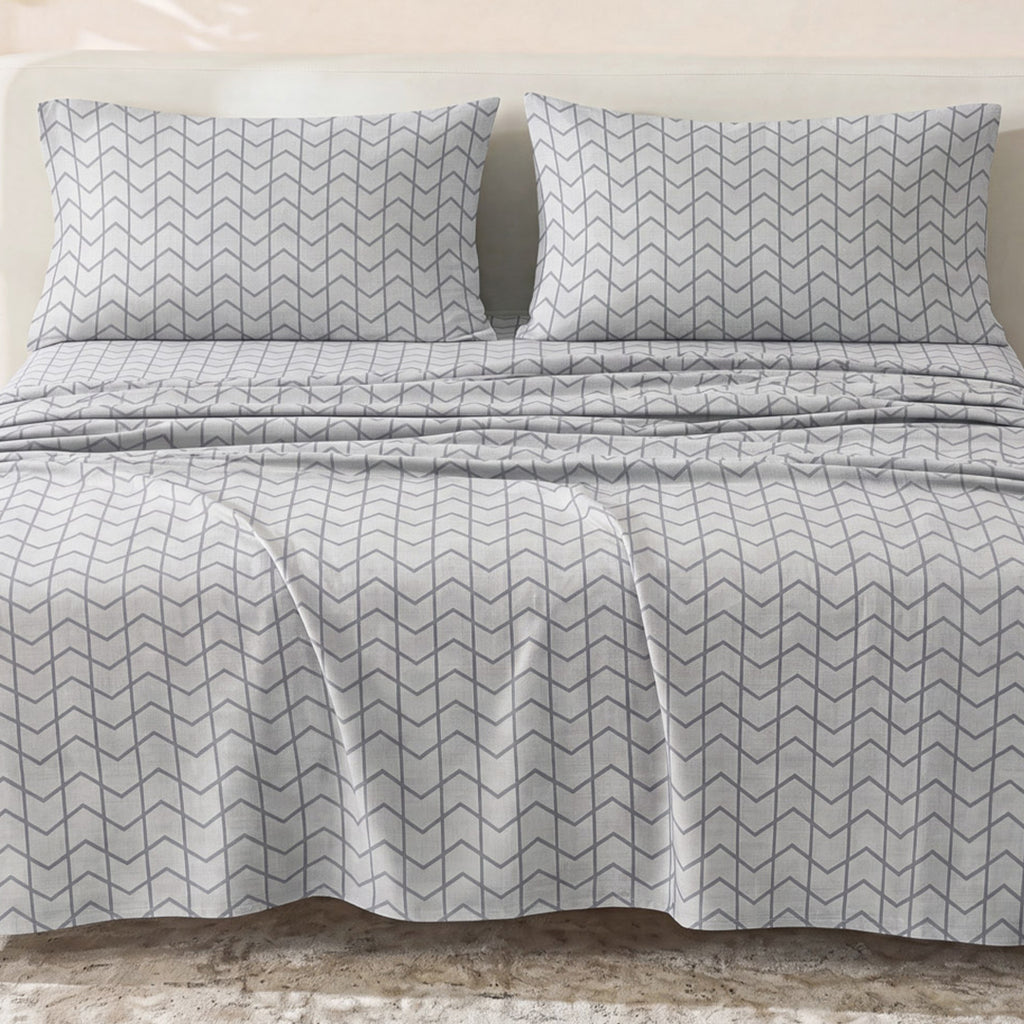 Sofia Home Textiles Printed Bedsheets - Sofia Large Zigzag Printed Double Flat Bedsheet Set 4 Pcs (240 × 260 cm) in Grey spread on a double bed - مفروشات صوفيا - ملايات مطبوعة - طقم ملاية صوفيا زجزاج كبير دبل مسطحة 4 قطع (240 × 260 سم) باللون رمادي مفروش على سرير دبل