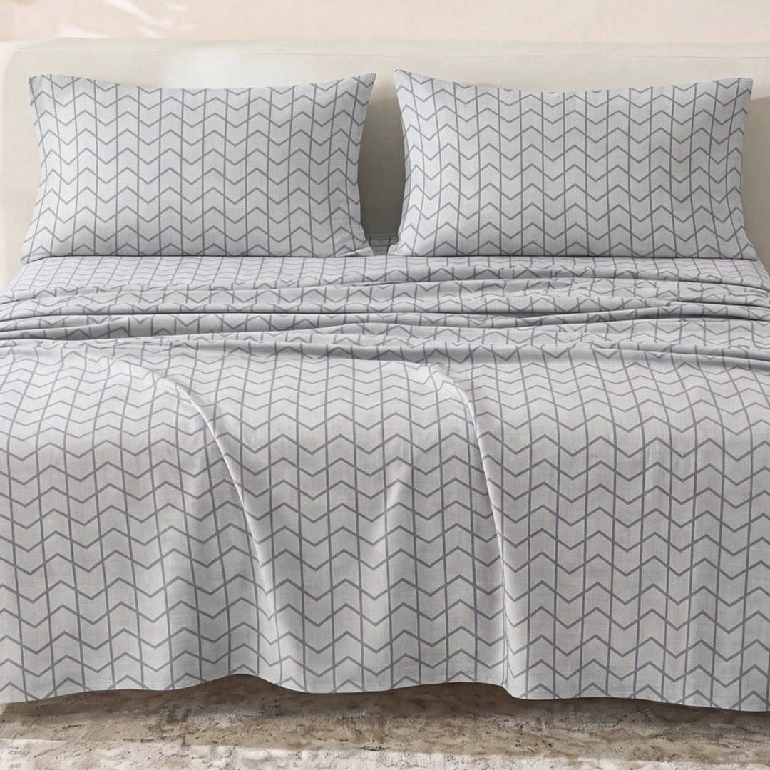 Sofia Home Textiles Printed Bedsheets - Sofia Large Zigzag Printed Double Flat Bedsheet Set 4 Pcs (240 × 260 cm) in Grey spread on a double bed - مفروشات صوفيا - ملايات مطبوعة - طقم ملاية صوفيا زجزاج كبير دبل مسطحة 4 قطع (240 × 260 سم) باللون رمادي مفروش على سرير دبل