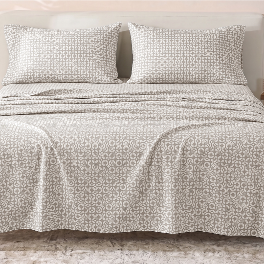 Sofia Home Textiles Printed Bedsheets - Sofia Geometric Flowers Printed Double Flat Bedsheet Set 4 Pcs (240 × 260 cm) in Grey spread on a double bed - مفروشات صوفيا - ملايات مطبوعة - طقم ملاية صوفيا ورد هندسي دبل مسطحة 4 قطع (240 × 260 سم) باللون رمادي مفروش على سرير دبل