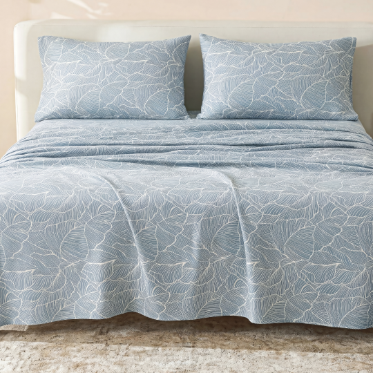 Sofia Home Textiles Printed Bedsheets - Sofia Large Leaves Printed Double Flat Bedsheet Set 4 Pcs (240 × 260 cm) in Teal spread on a double bed - مفروشات صوفيا - ملايات مطبوعة - طقم ملاية صوفيا ورق شجر كبير دبل مسطحة 4 قطع (240 × 260 سم) باللون جنزاري مفروش على سرير دبل